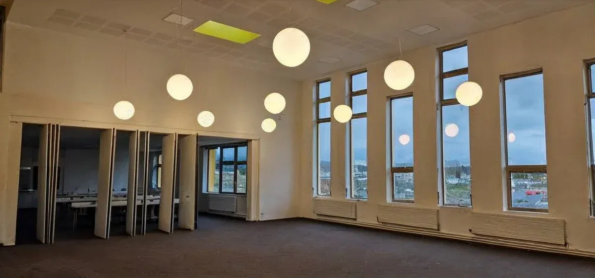 Bright school interior with pendant lighting installed for Gaelcholaiste Chiarraí